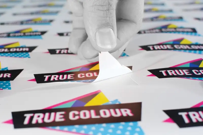 A close-up of a finger touching a sticker